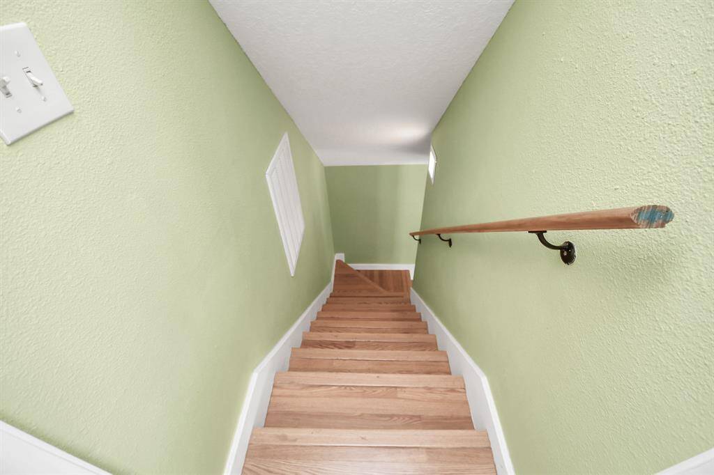 Elegant stairway leading down from the second level.