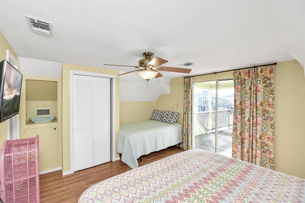 Bright second-floor bedroom with direct access to a spacious upper deck.