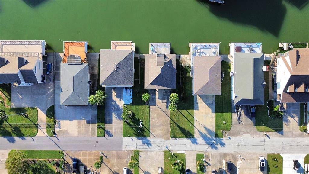 Stunning aerial view of waterfront homes, showcasing prime location with direct canal access and serene surroundings.