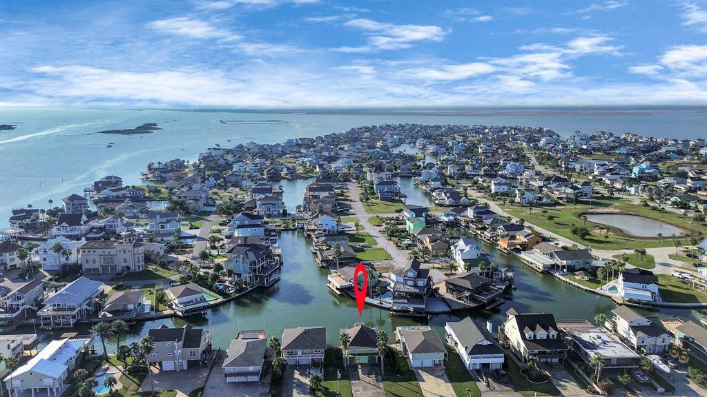 Stirring aerial view of waterfront homes showcasing prime location with direct canal access and serene surroundings