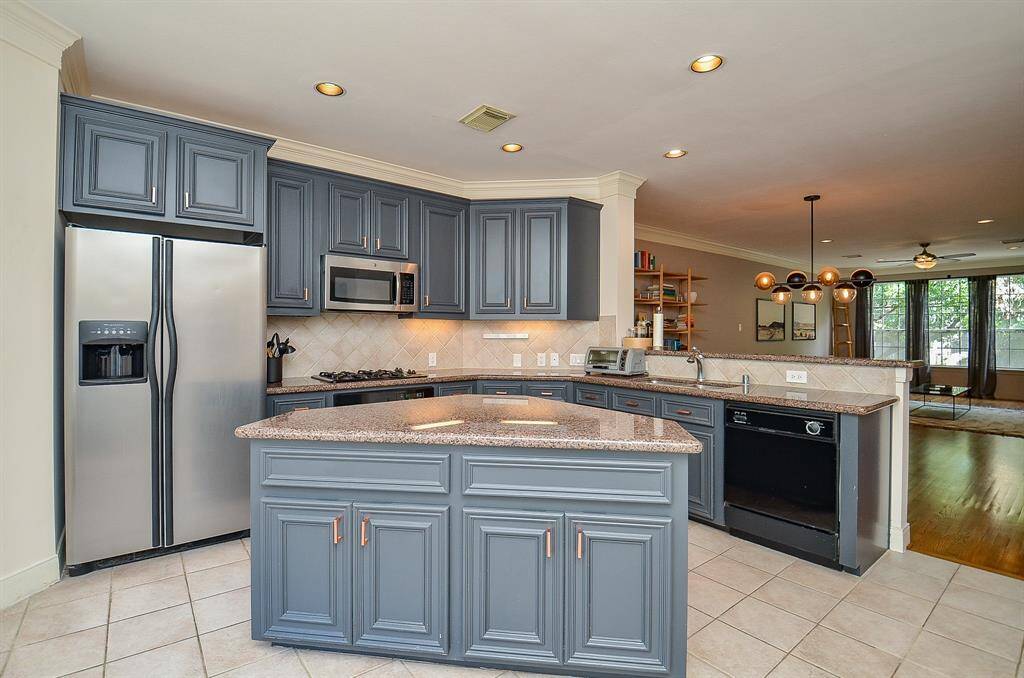 This darling island offers more storage and more counter surface space with clever angles for another stool or so, if desired.