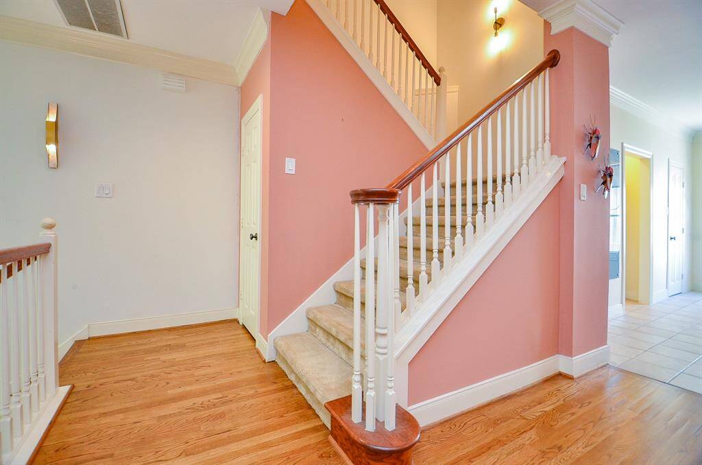 Peachy tones on the walls of this portion of the carpeted staircase are visually enchanting.