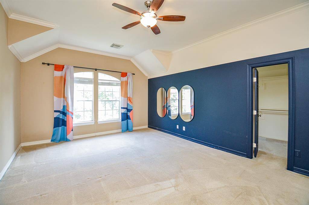 Incredible space and a bright touch of color delights the senses in your primary suite, with the walk-in closet beyond the open door, right.
