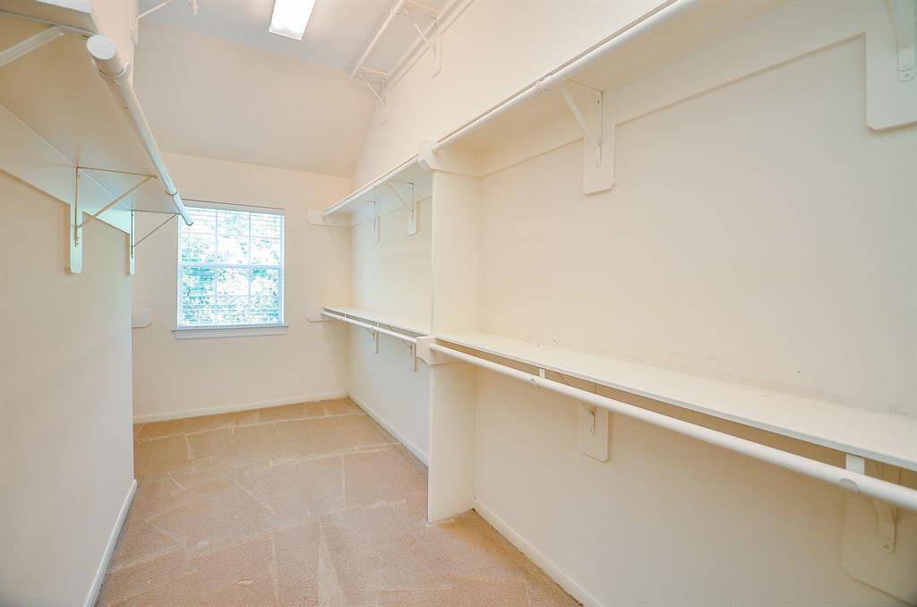 Wow! Your primary walk-in closet will organize and neatly store just about everything you own in one place, with a bonus window!