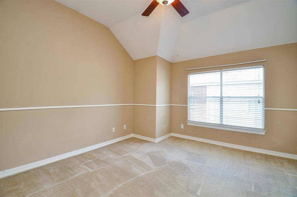 A lush carpeted third bedroom pleases with earth toned walls and carpeting.