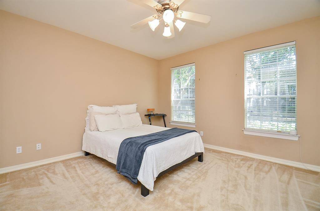 Large dual windows bring pure natural light into this spacious carpeted secondary bedroom located on the first floor.