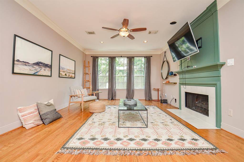 What a marvelous living/family area, with high ceiling, tremendous wall and floor space, and the charming gas log fireplace, right. A trio of big windows brings natural light into this amazing space.