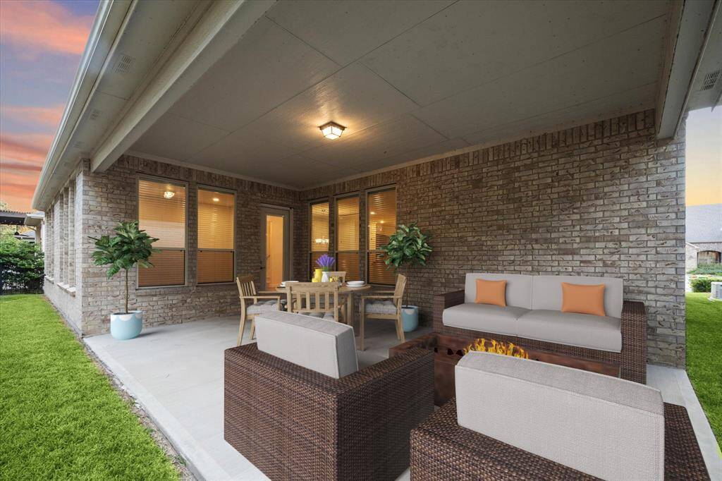 Staged outdoor covered patio with plenty of space for table, chairs, a built-in grill or outdoor fireplace. The perfect place to sit any time of the year.