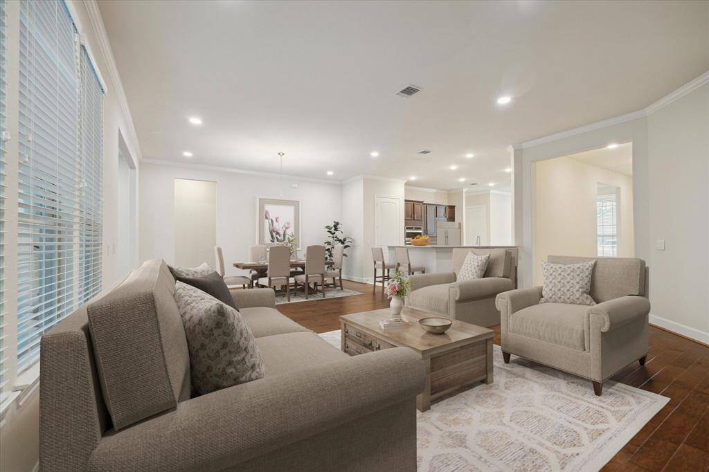 Spacious great room staged with living room and dining room furniture. The space can acomodate large pieces of furniture in a multitude of layouts. Spacious enough for a sectional, multiple couches, or an oversized couch and chairs.