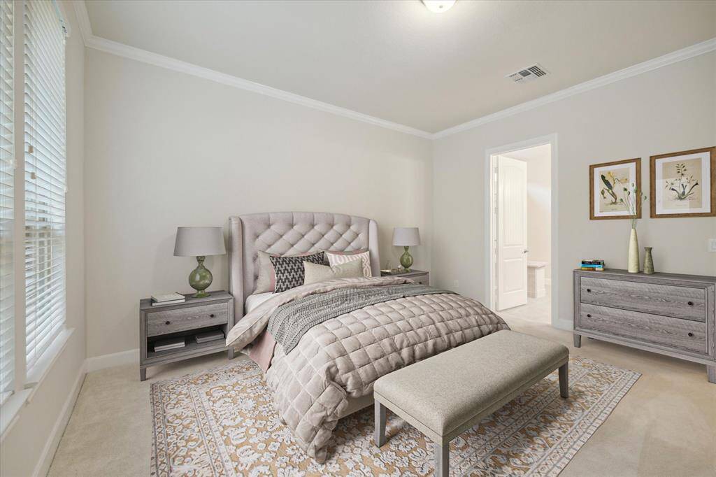Primary bedroom staged with large furniture for scale. This room overlooks the backyard.