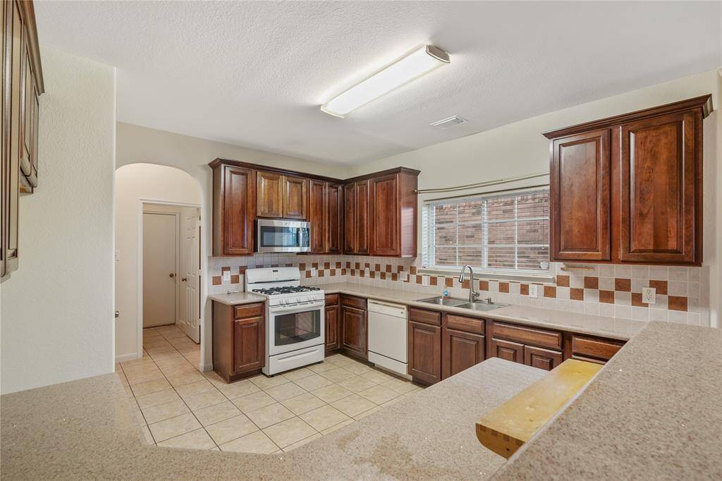 Maximize your culinary experience in this spacious kitchen, complete with abundant storage options.