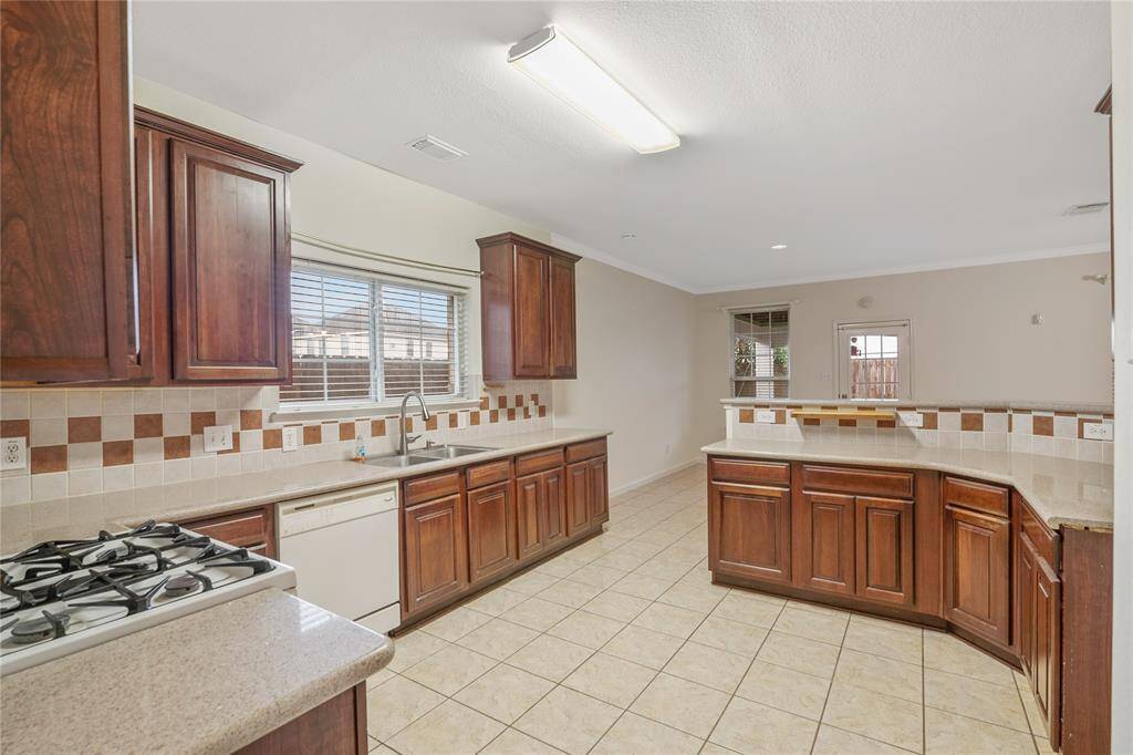 Experience culinary delight in this expansive kitchen designed for shared cooking and entertaining.