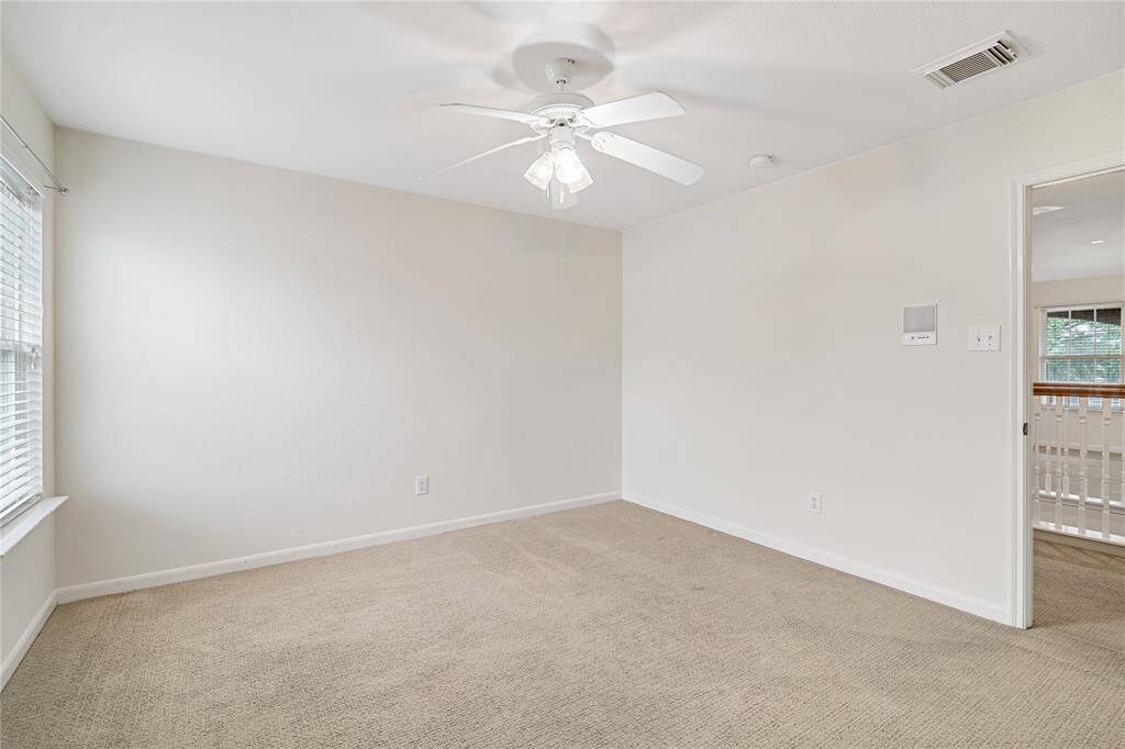 Another upstairs bedroom with ample natural light.