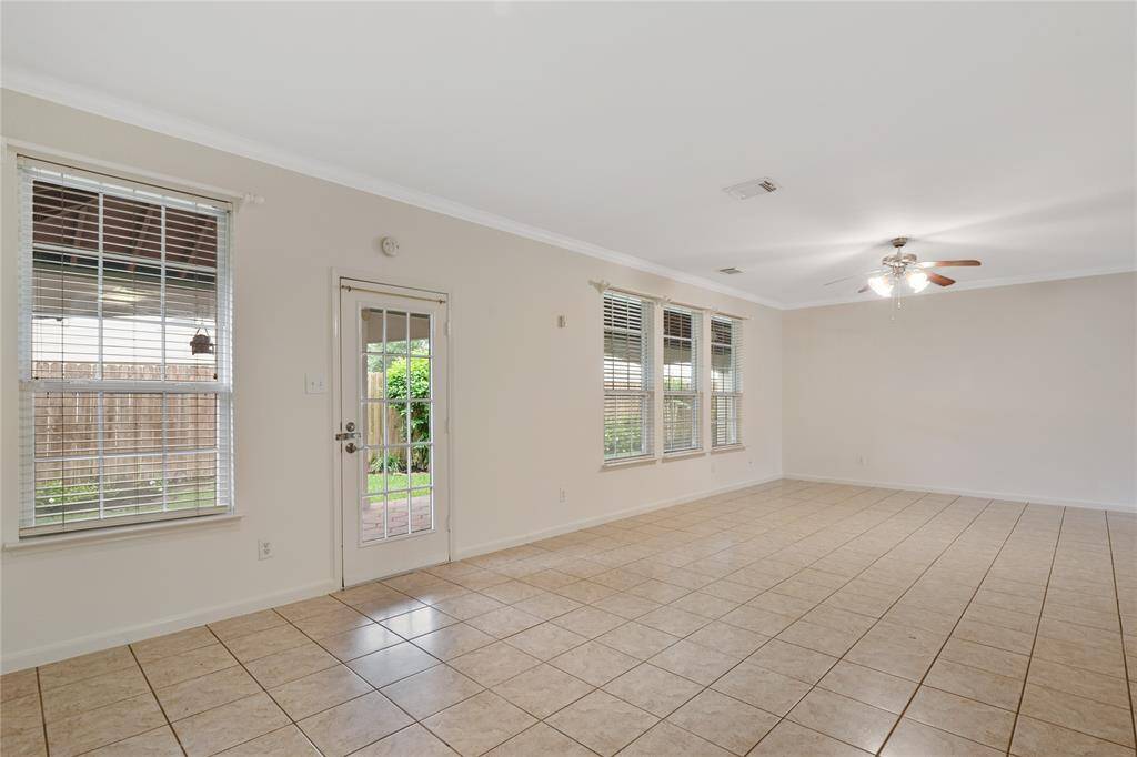 Spacious den with scenic views of the expansive, shelteredd backyard patio.