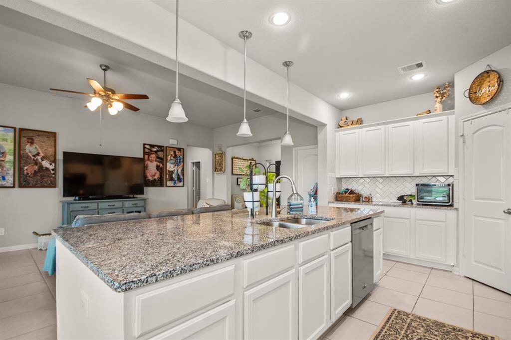 Large island with sink and dishwasher, plus plenty of storage space