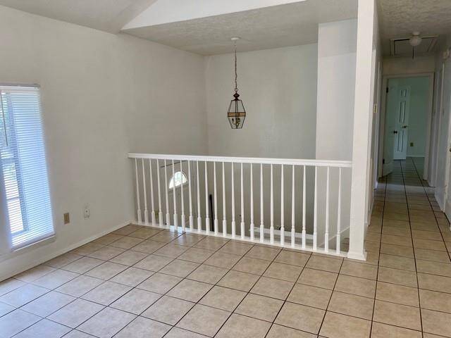 Large family room with big windows and easy clen tile flooring.