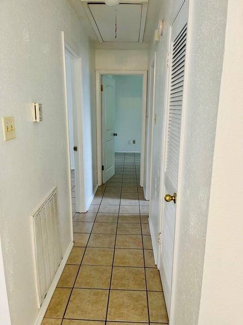 Hallway to two bedrooms and full bathroom.