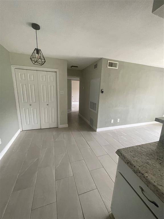 Conveniently located, the washer and dryer are discreetly tucked behind closed doors.