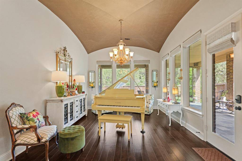 The piano room has a vaulted ceiling and  6 large windows with shades controlled by remote control. Includeds the glass door to the patio.