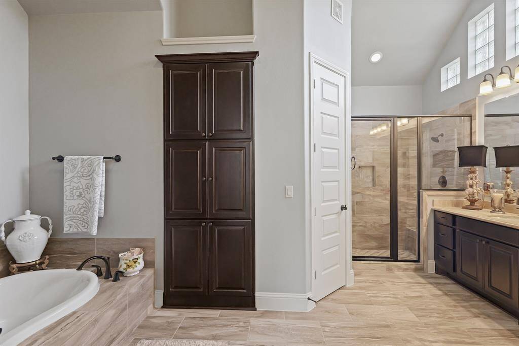 The vanity is quite large as is the walk in shower. All tile floor.