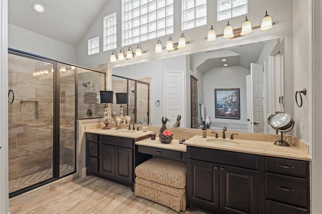 Executive primary bath: double sinks, knee hole seating, separate shower and walk in closet as well as again high ceilings allowing for natural light.