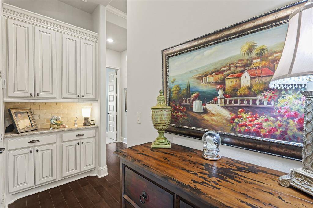 Entrance from the garage shows more of the beautiful custom millwork leading to the kitchen.