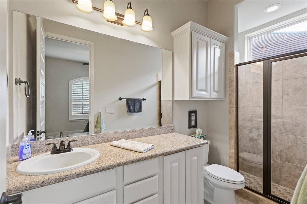 Bath with natural light from high window and large walk in shower.