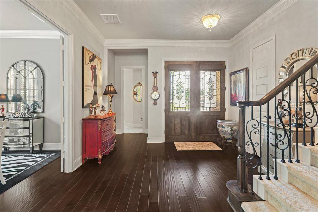 Looking back at double front doors: left is the formal dining by these owners but with the French doors also can serve as a study / home office.