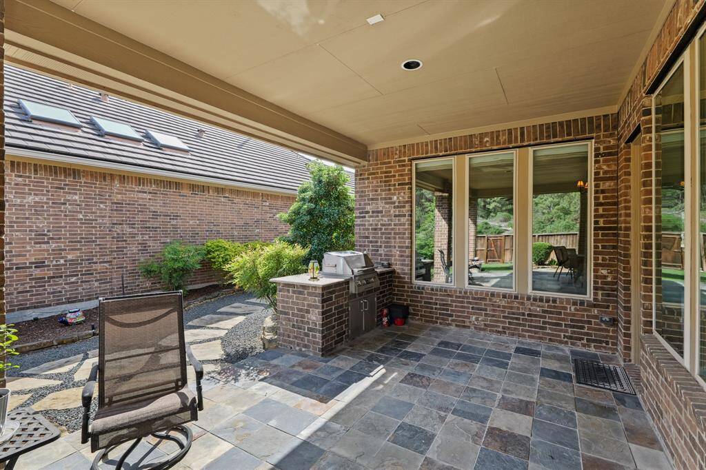 Outdoor kitchen in the corner provides for outdoor entertaining and summer fun.