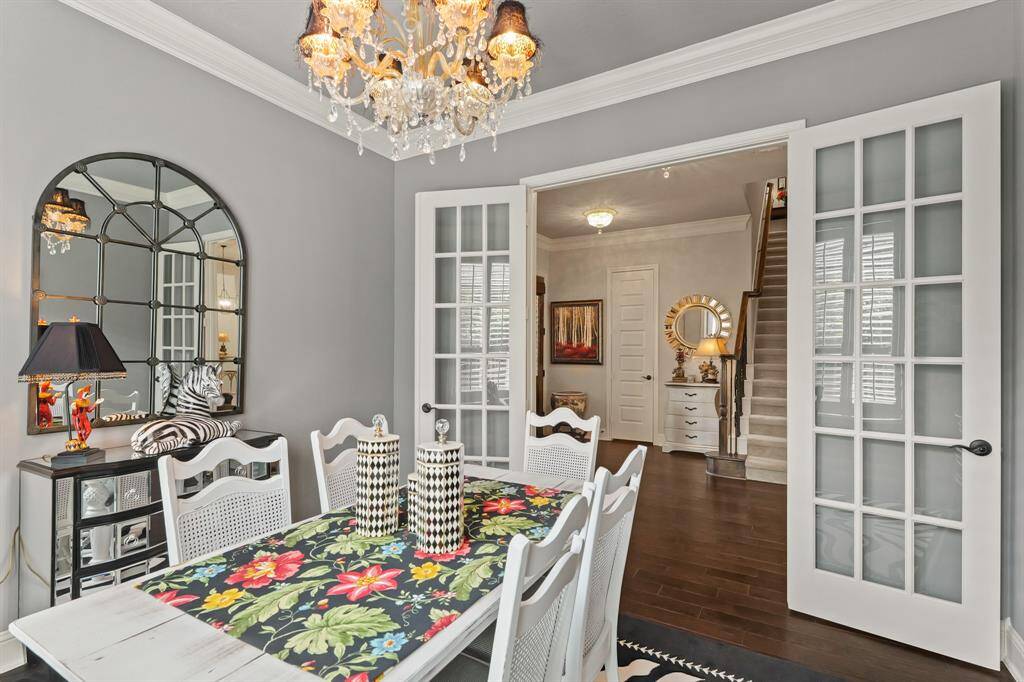 Formal dining room - OR - study / home office. Crown molding is everywhere as well as gorgeous chandeliers.