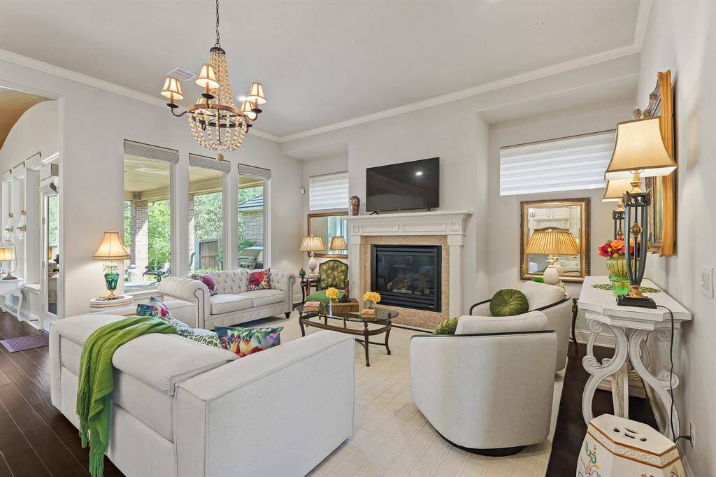 Lovely living room is accented with a center fireplace and television location over it. All of the windows have remote controlled window shades.