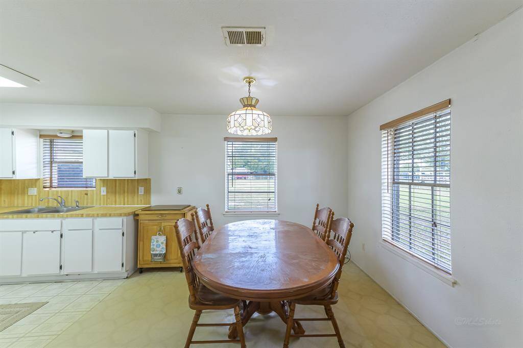 Casual dining space features bright windows.