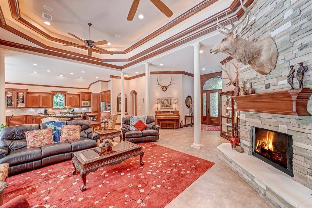 Stacked Stone Gas Fireplace, Tile and Wood flooring Throughout. 9 High End Variable Speed Ceiling Fan/Light Fixtures throughout.