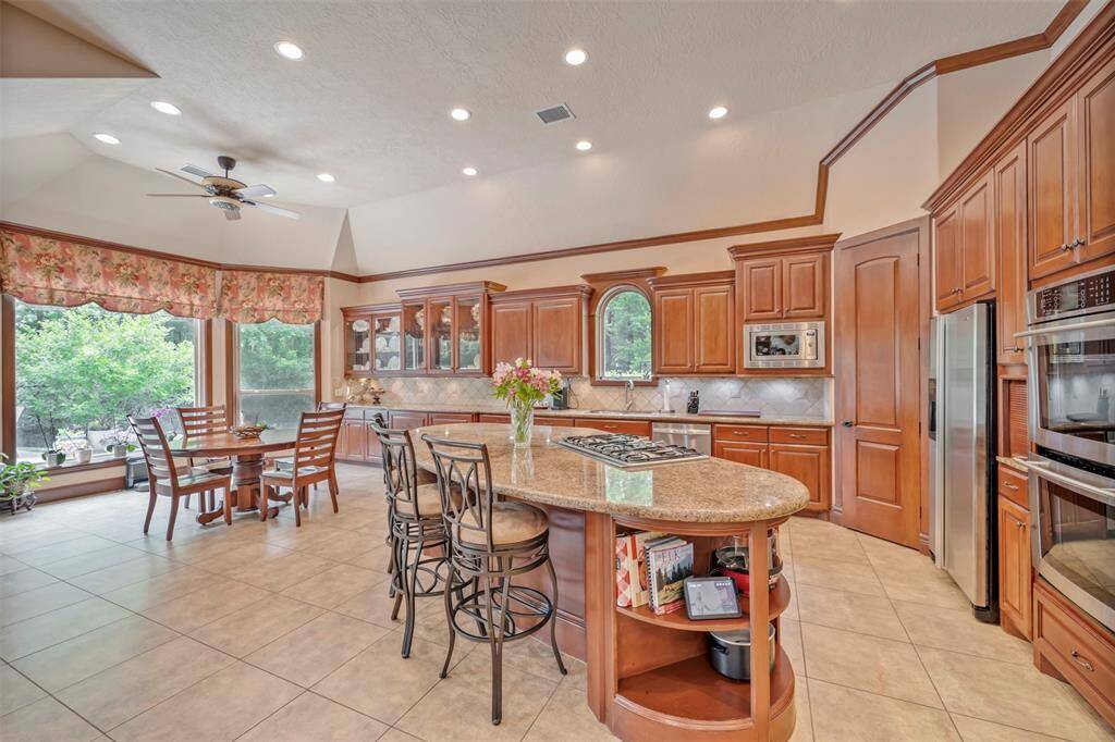 Definitely a Chefs Delight with Granite Counterspace, Gas downdraft Cooking, Double ovens, Walk-in PantryCustom Cabinetry with Appliance Drawers, Pan Drawers