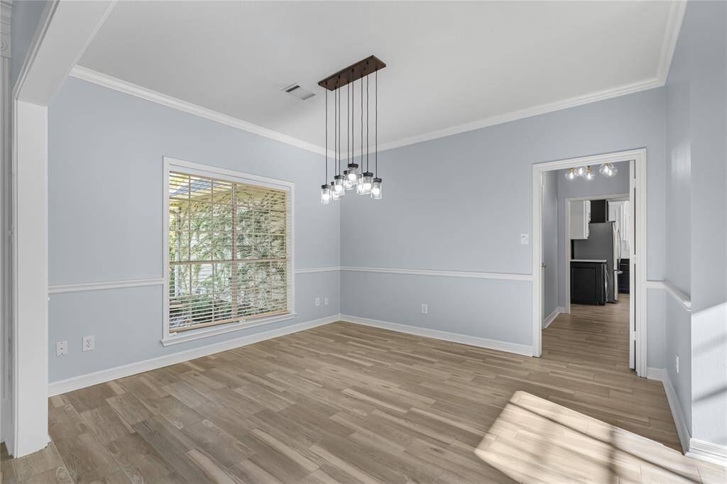Views of dining room off of entry leading to half bath and kitchen.