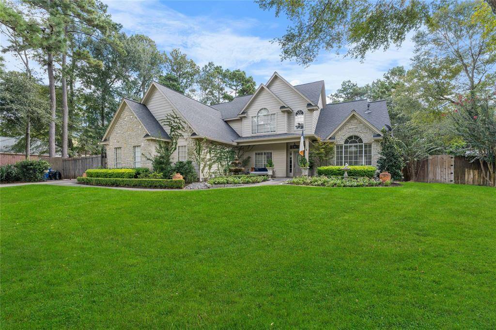 Situated on over an acre, this fully fenced two-story home offers a gorgeous exterior, featuring a large, manicured lawn and mature trees, offering both curb appeal and privacy.
