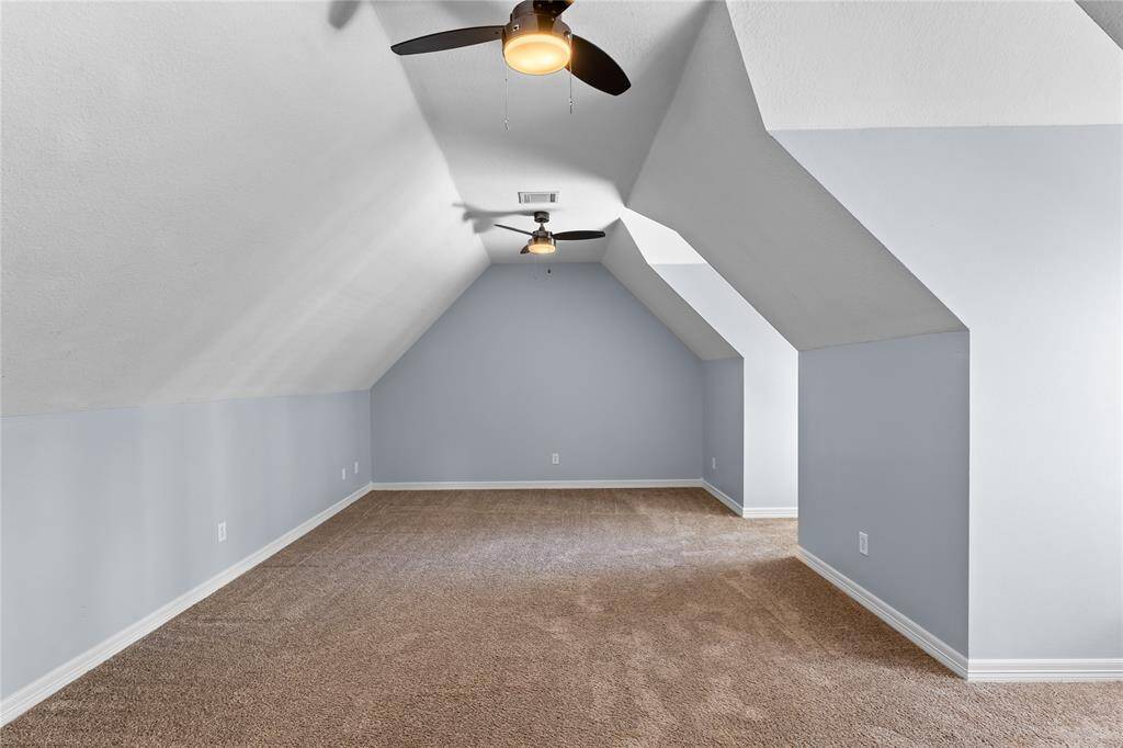 Another view of flex room offering two ceiling fans, and a fresh, neutral color scheme.