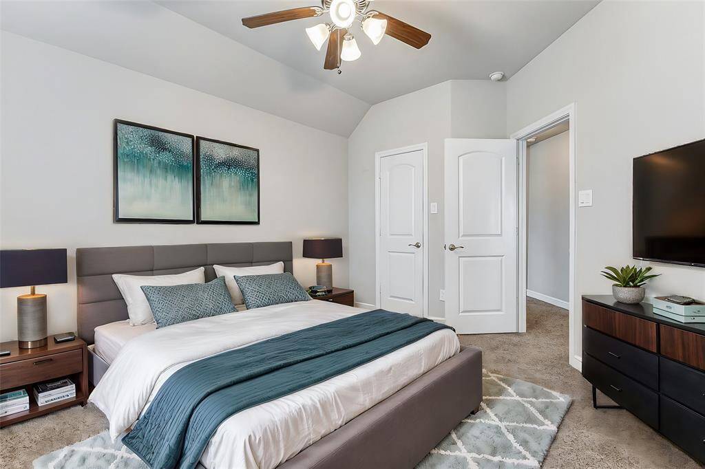 This secondary bedroom offers a peaceful retreat with plush carpet and a ceiling fan for added comfort. With a spacious closet and plenty of natural light, this room is perfect for guests, family members, or even a dedicated home office.