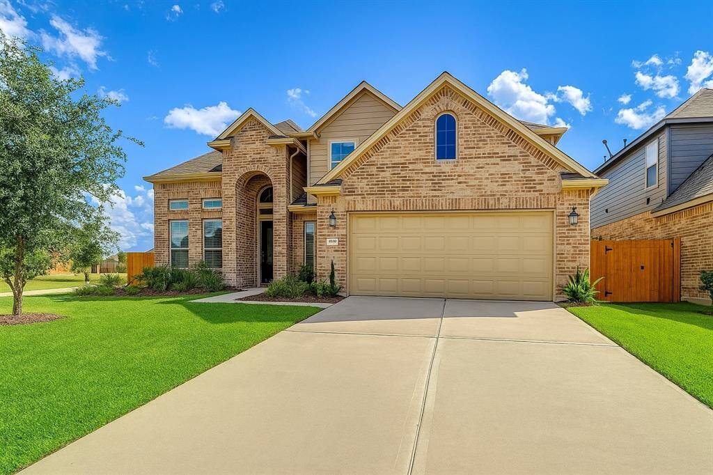 With its traditional architecture and eye-catching brick design, this residence offers a warm welcome to all who visit. The tall arch over the entryway exudes a sense of grandeur, while the tidy landscaping and spacious driveway enhance the property’s polished look. Positioned on a prime corner lot, this home is as functional as it is beautiful, making it perfect for modern family living.