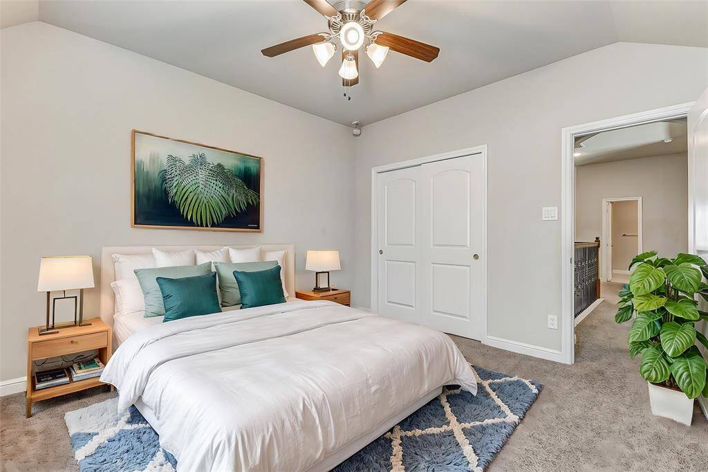 A spacious retreat awaits in this airy bedroom, featuring plush carpeting and ceiling fan for comfort. The neutral color palette and ample wall space provide the perfect backdrop for personalization. With large windows letting in ample light, this room becomes a private haven of relaxation, ready to adapt to any style and decor preferences.