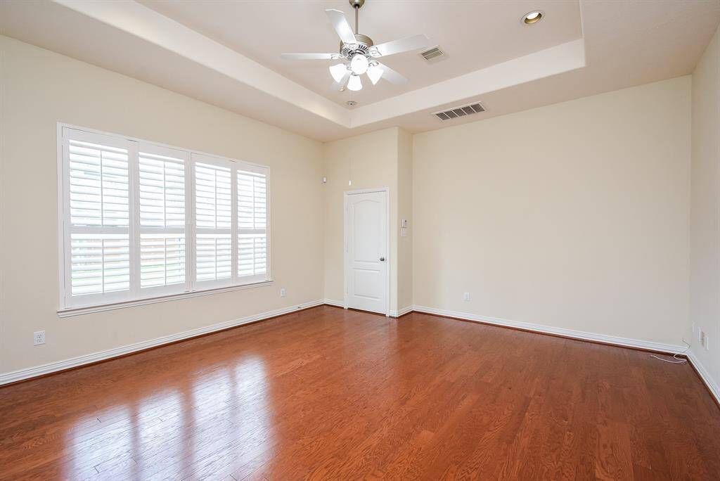 Wall of windows overlooking the back yard - allows plenty of light.  Notice the beautiful, gleaming wood floors!