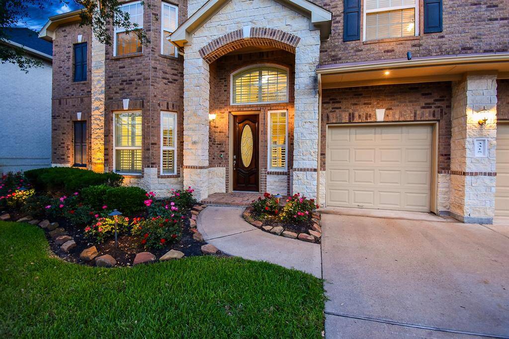 Beautiful custom landscaping and curved sidewalk welcome you to this gorgeous home!