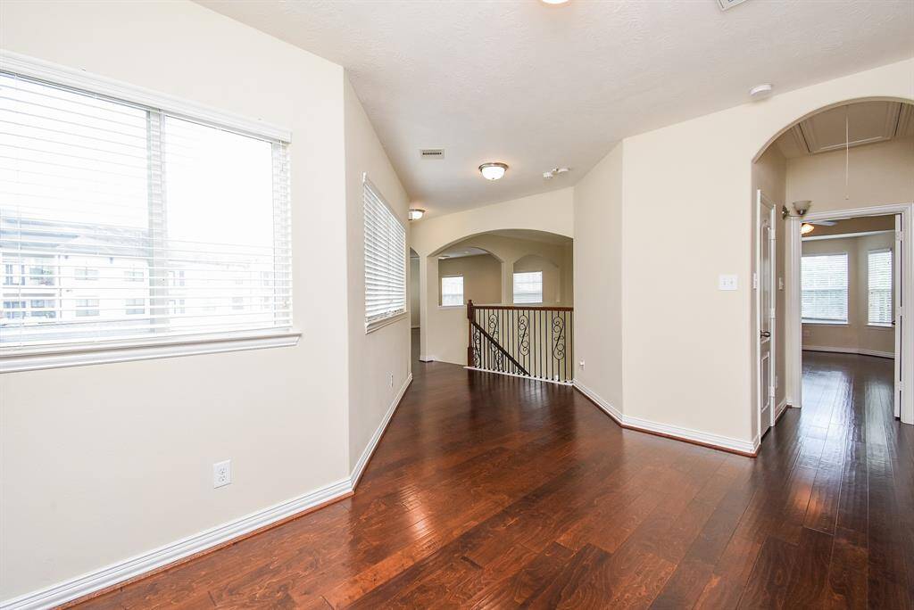Open hallway area with large windows overlooking the back yard.
