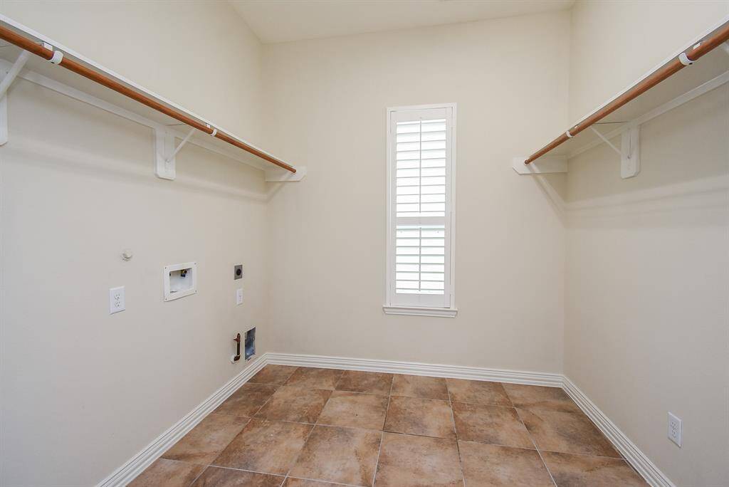 Large Utility Room with window and bars for hanging clothes.