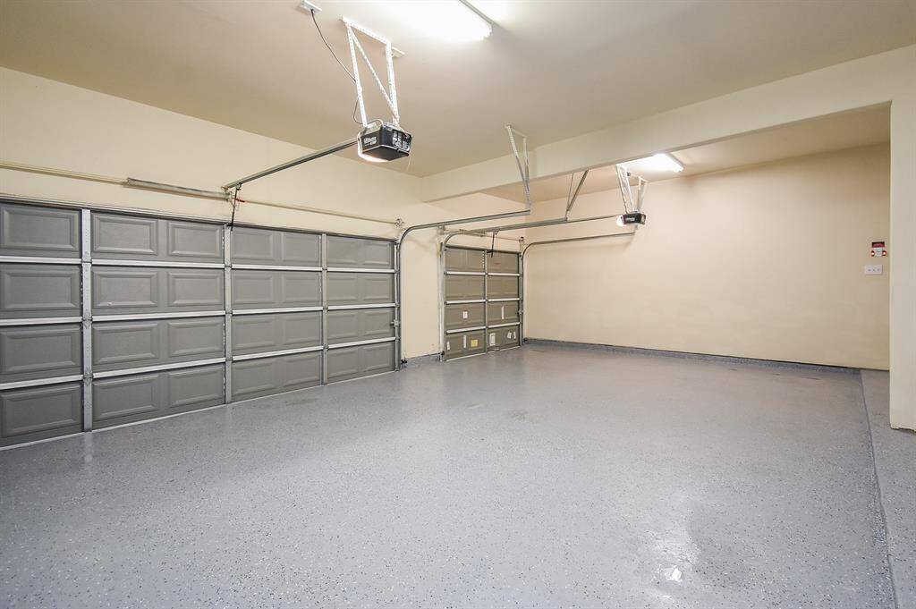 Oversized 3-Car Garage with epoxy coated floors and 2 automatic garage doors.