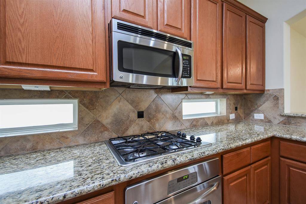 Kitchen features stainless appliances, granite counter tops and extensive storage/cabinets.