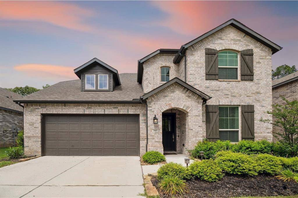Welcome home! The tasteful color scheme of the brick contrasted with the dark wood shutters create a beautiful front elevation.