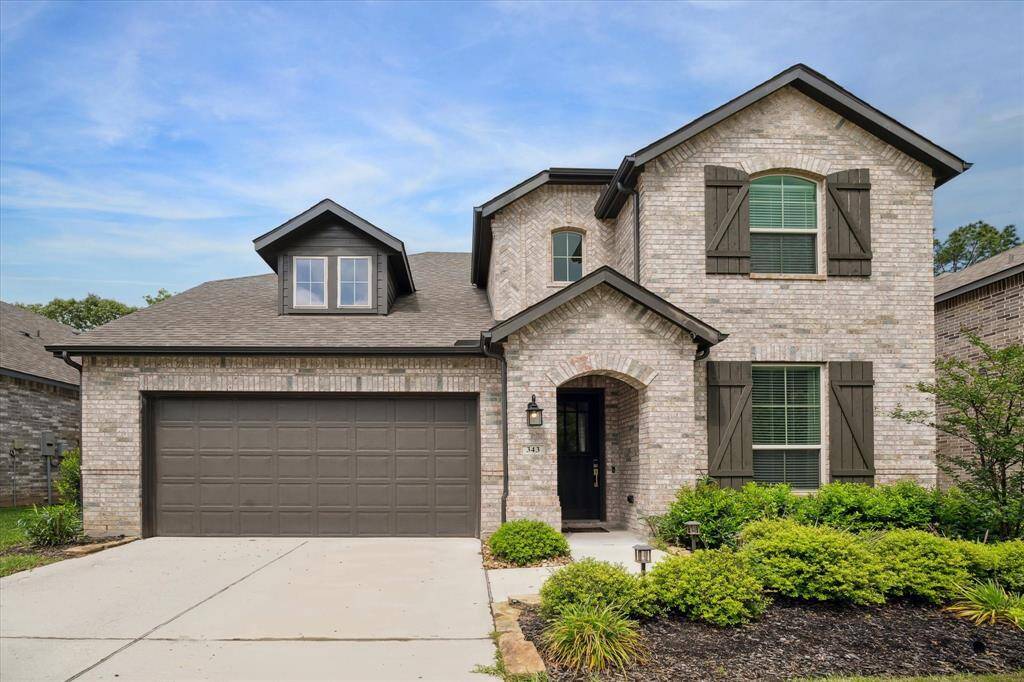 Welcome home! The tasteful color scheme of the brick contrasted with the dark wood shutters create a beautiful front elevation.