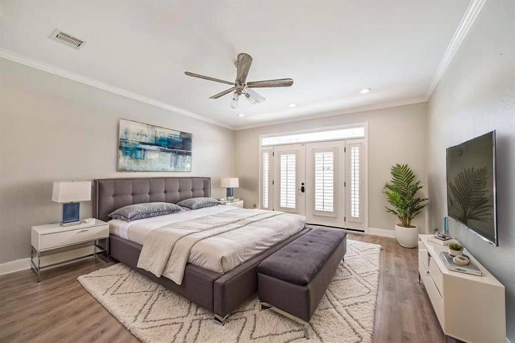 PRIMARY BEDROOM OFFERSA FRENCH DOORS LEADINGTO THE BACKYARD. ***Thisroom has been virtually staged.