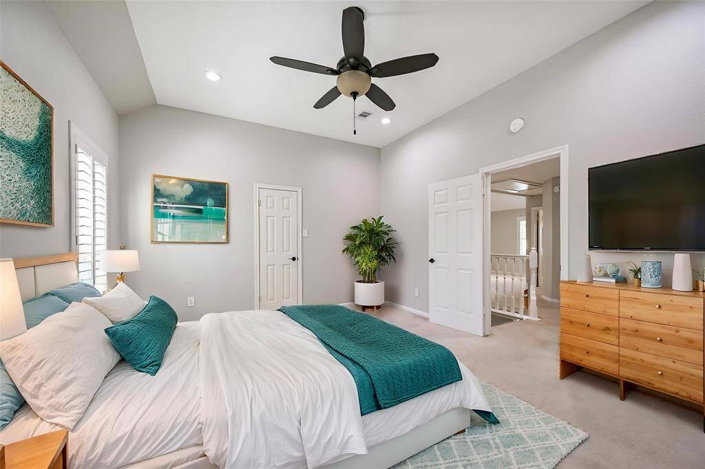 BRIGHT AND AIRY BEDROOM WITH VAULTED CEILING, PLANTATION SHUTTERS, AND NEUTRAL TONES. **This room has been virtually staged.